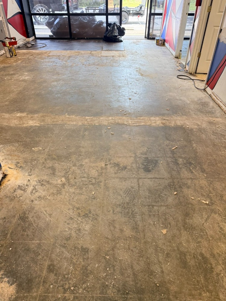 Same store floor swept clean and empty after Load Bros cleanup